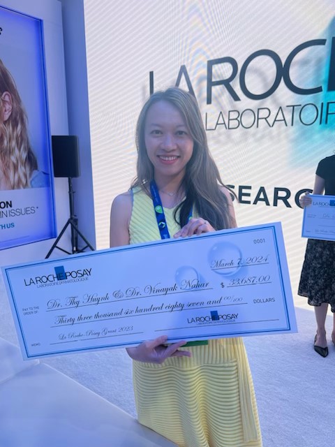 Dr. Thy Huynh poses with a check from La Roche-Posay's Research Grant Foundation at the American Academy of Dermatology annual meeting in San Diego.